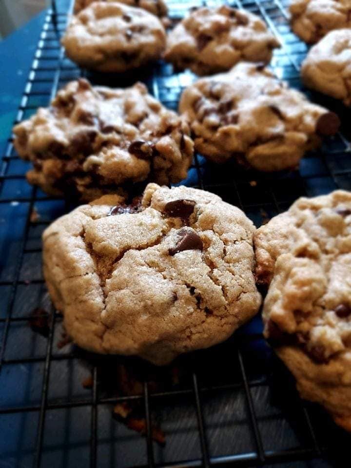 Chocolate Chip Cookies on a baking rack on a blue table